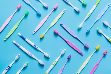 Top view of toothbrushes in colorful on pastel color background.