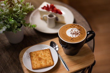 Hot coffee in a cup on wooden table
