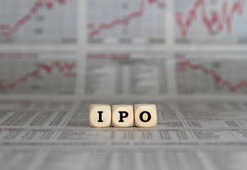 Initial Public Offering on wooden cubes on a busibess newspaper