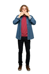 Full-length shot of Blonde man covering mouth with hands over isolated white background