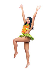 The ethnic woman in banana skirt dancing savage dances, isolated on white background. Exotic female dancer jumping with hands up.