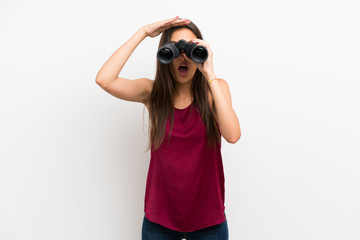 Young woman over isolated white background with black binoculars