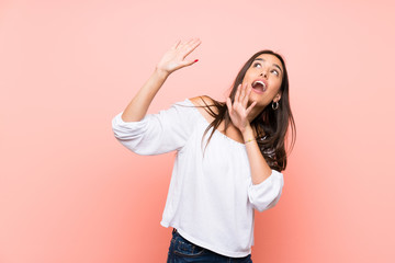 Young woman over isolated pink background nervous and scared