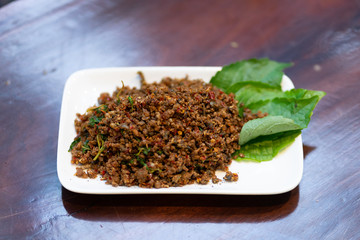 Close up Fried Spicy Frog with herb on white plate is thai food and thailand