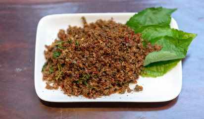 Close up Fried Spicy Frog with herb on white plate is thai food and thailand