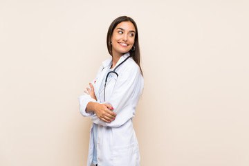 Young doctor woman over isolated background laughing