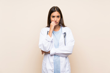 Young doctor woman over isolated background thinking an idea