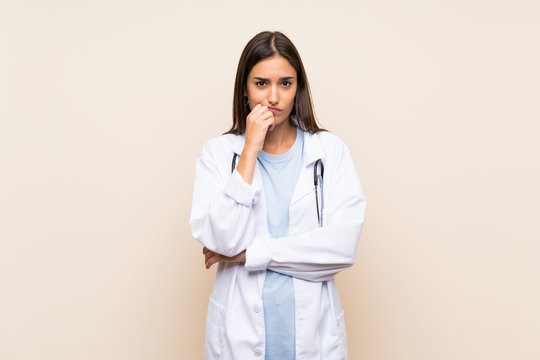 Young doctor woman over isolated background thinking an idea