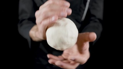 Chef makes scones from dough on a dark background