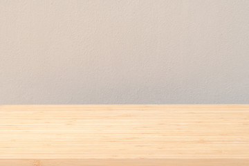 Wood desk tabletop texture isolated on concrete wall background