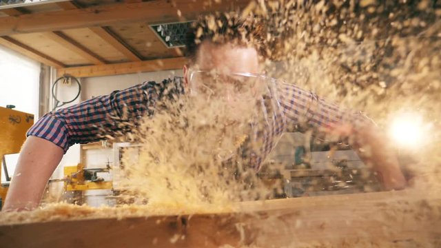 Slow motion of wood chippings getting blown away