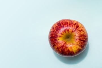 One red apple placed on the table.