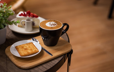 Hot coffee in a cup on wooden table