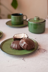 Chocolate marshmallows in mint cup. on a wooden table