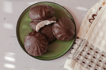 Chocolate marshmallows in mint cup. on a wooden table
