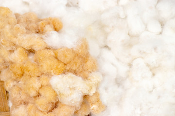 heap of brown and white cotton wool from cotton flowers in basket.