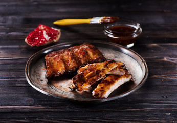   barbecued ribs on the plate and spicy marinade