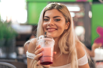 Girl drinking a strawberry smoothie