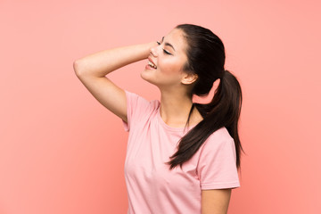 Obraz premium Teenager girl over isolated pink background laughing