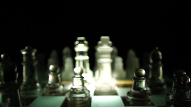The concept of business competition: Close-up of a businessman holding a glass chess footage slow motion