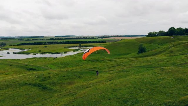 A person is flying the parawing in a top view