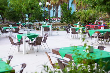 Empty tables of the summer restaurant of the hotel. Free tables and chairs a summer restaurant on the terrace, in the open air.
