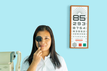 Women are checking eyesight.,Check your eyesight , Woman in optical shop ,on a blue background