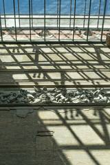  Upwards perspective of the shadow patterns coming from the roof of the Berlin's Museum Island, Neues Museum, and an exhibition of statues into the wall