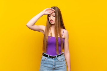 Young woman over isolated yellow background with tired and sick expression
