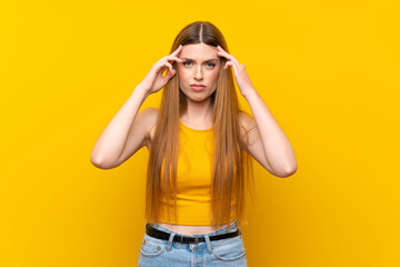 Young woman over isolated yellow background unhappy and frustrated with something. Negative facial expression