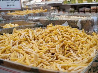 Mound of dried gemelli pasta in storage ready to cook