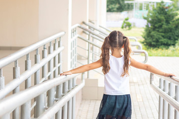 first day of school. Girl schoolgirl goes to first grade. Girl playing, running after school