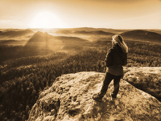Fototapeta premium Girl watch Sun rising at horizon. Colorful spring valley