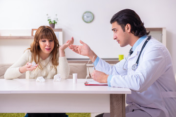 Young female patient discussing with male psychologist personal