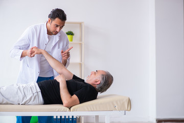Obraz premium Old injured man visiting young doctor
