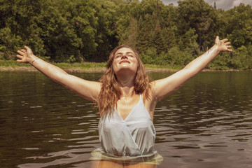 young woman arms out in water