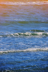 Abstract clean sea background, view on ripple foam surface of water. Deep turquoise blue ocean waves. Calm ocean water background landscape. Clear water wave texture. Marine aqua at tropical summer.