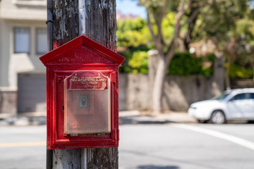 Department of electricity red fire alarm posted outside in residential neighborhood