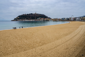 The famous La Concha beach in San Sebastian in cloudy winter day, Basque Country, Spain
