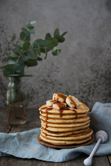 American  pancakes with banana and  caramel. Vertical orientation
