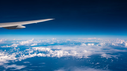 Fototapeta na wymiar Skyline View above the Clouds from airplane