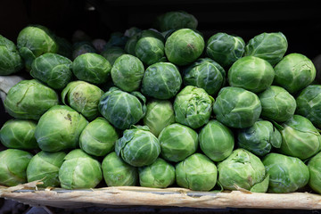 Mound of fresh brussels sprouts for sale in produce section at supermarket