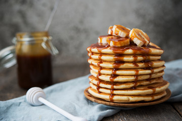 American pancakes with banana and caramel. Vertical orientation