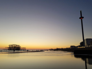 Beautiful sunset view at Brighton Pier with Brighton beach sea, sand and the highest and tallest...
