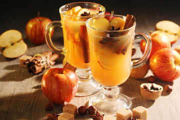 Two cups with hot cider in cold season with cinnamon and anise