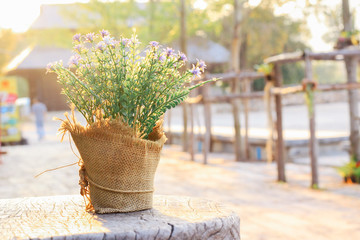 bouquet of flowers in vase on wooden table