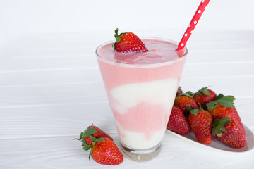 Strawberry smoothies pink colorful fruit juice beverage healthy high protein the taste yummy in glass on white wood background.