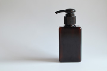 Model of a brown bottle with a squeeze cap on a white background,mockup