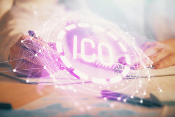 Cryptocurrency hologram over woman's hands writing background. Concept of blockchain. Double exposure