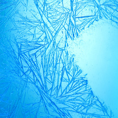 Frost pattern ice crystals abstract background. Macro view frozen window frame